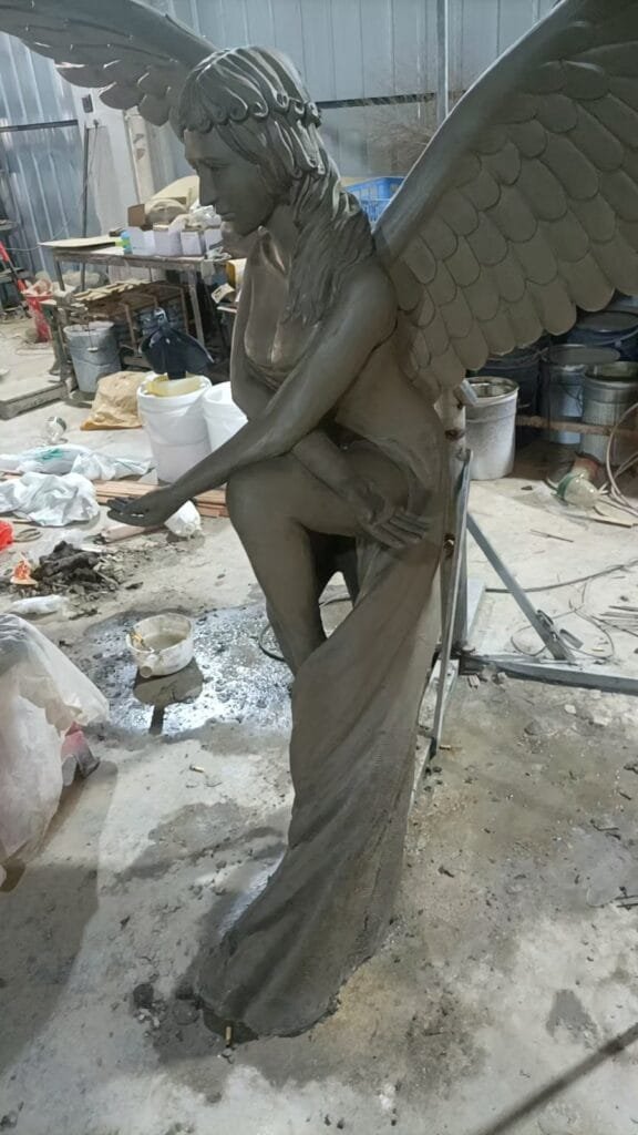 Fiberglass angel sculpture being fabricated in an AlisnArt workshop before finishing