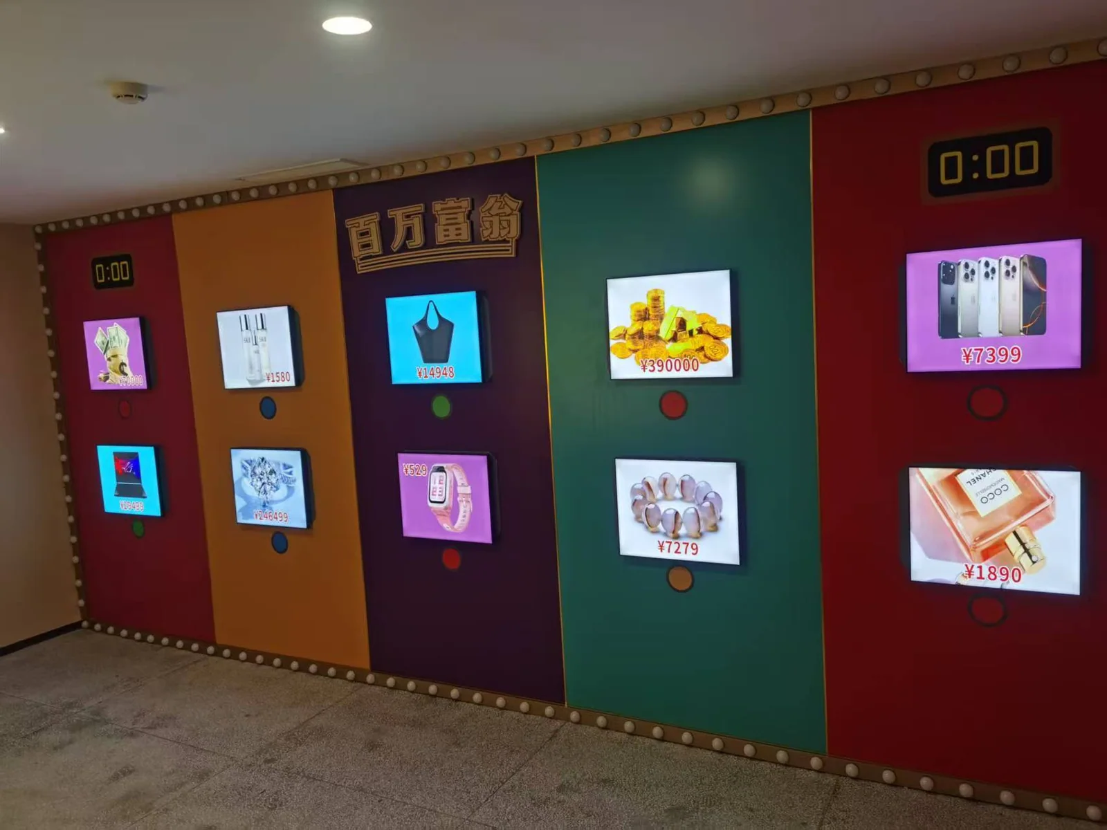 A colorful Millionaire game screen wall with product images, price displays and round buttons in an exhibition room.